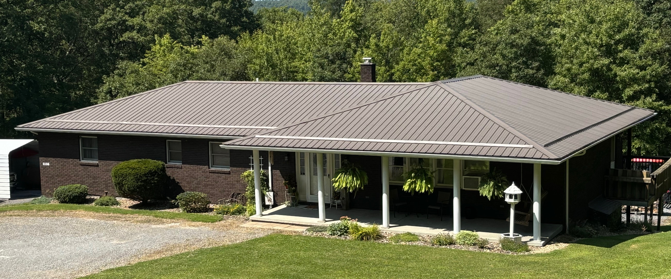 Double Hip Roof house with metal roofing.